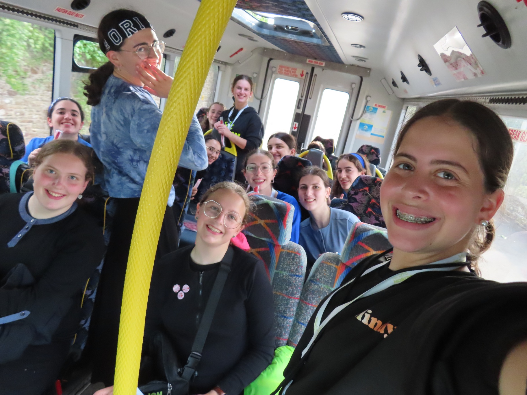 Young carers on a coach smiling together