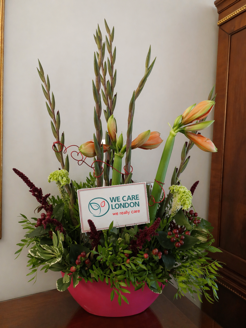 A floral arrangement with a We Care London card.