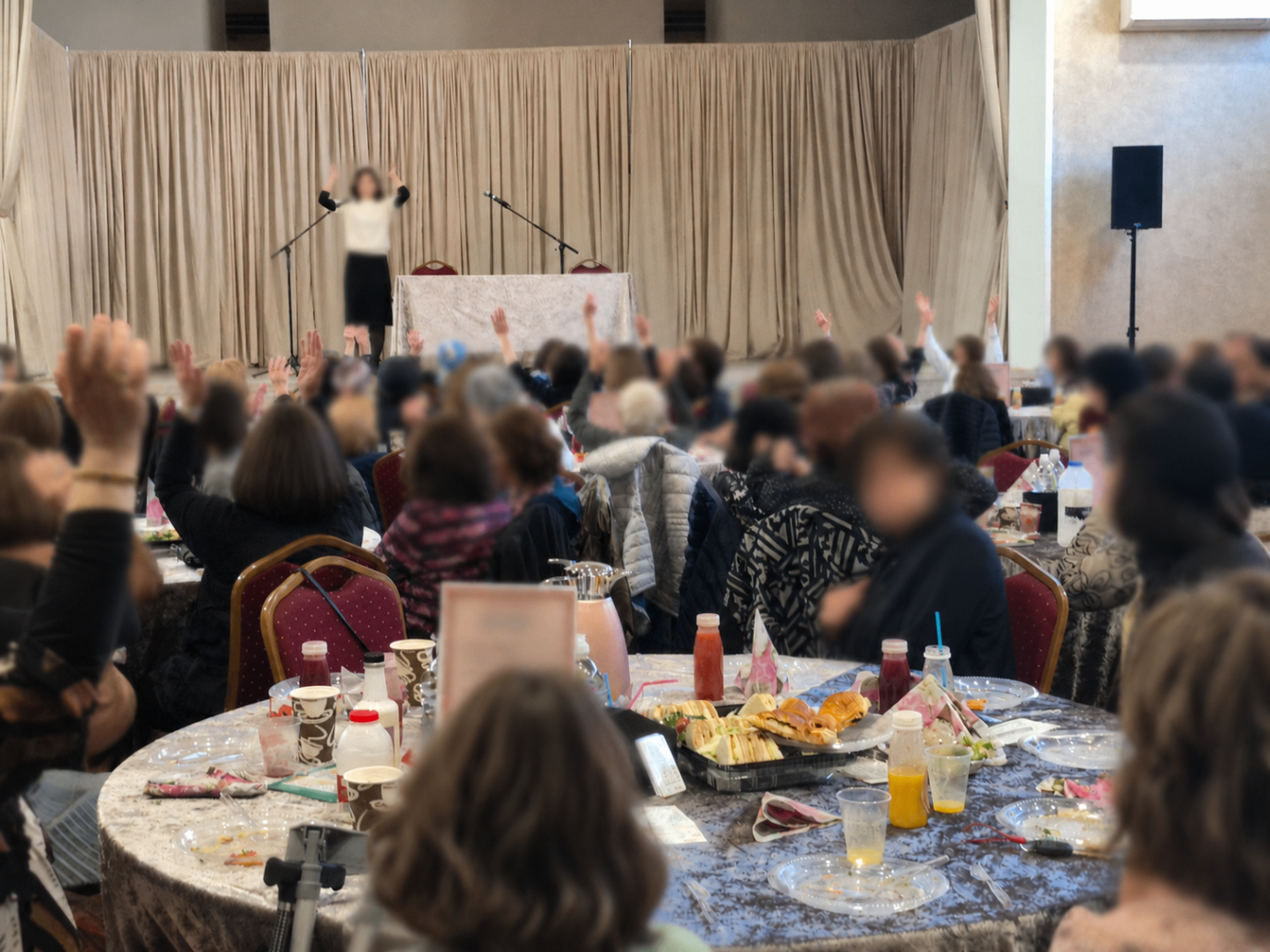 A large community gathering of older people and families at a Golden Hour event.