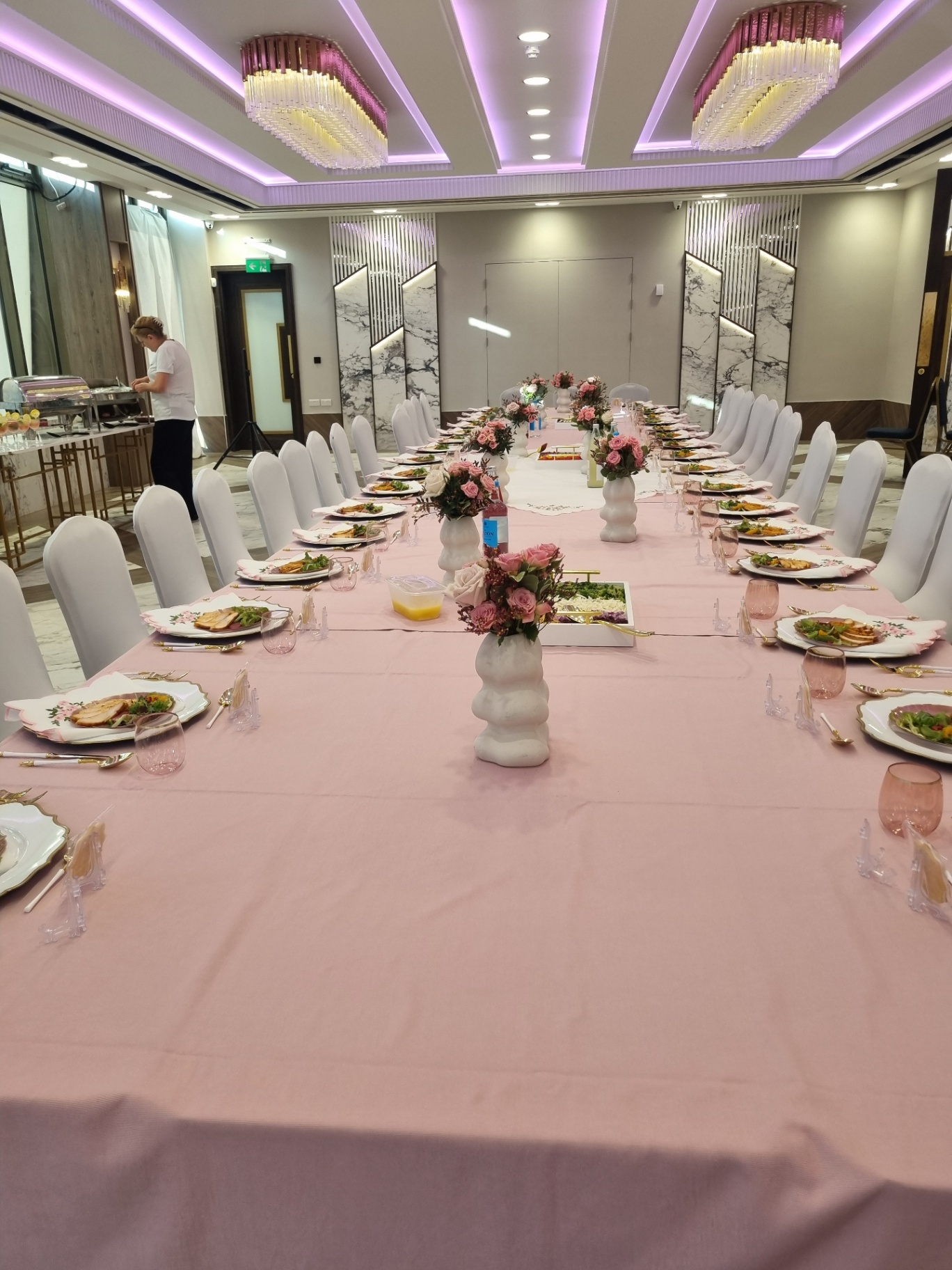 A carefully prepared pink table set for a shared meal.